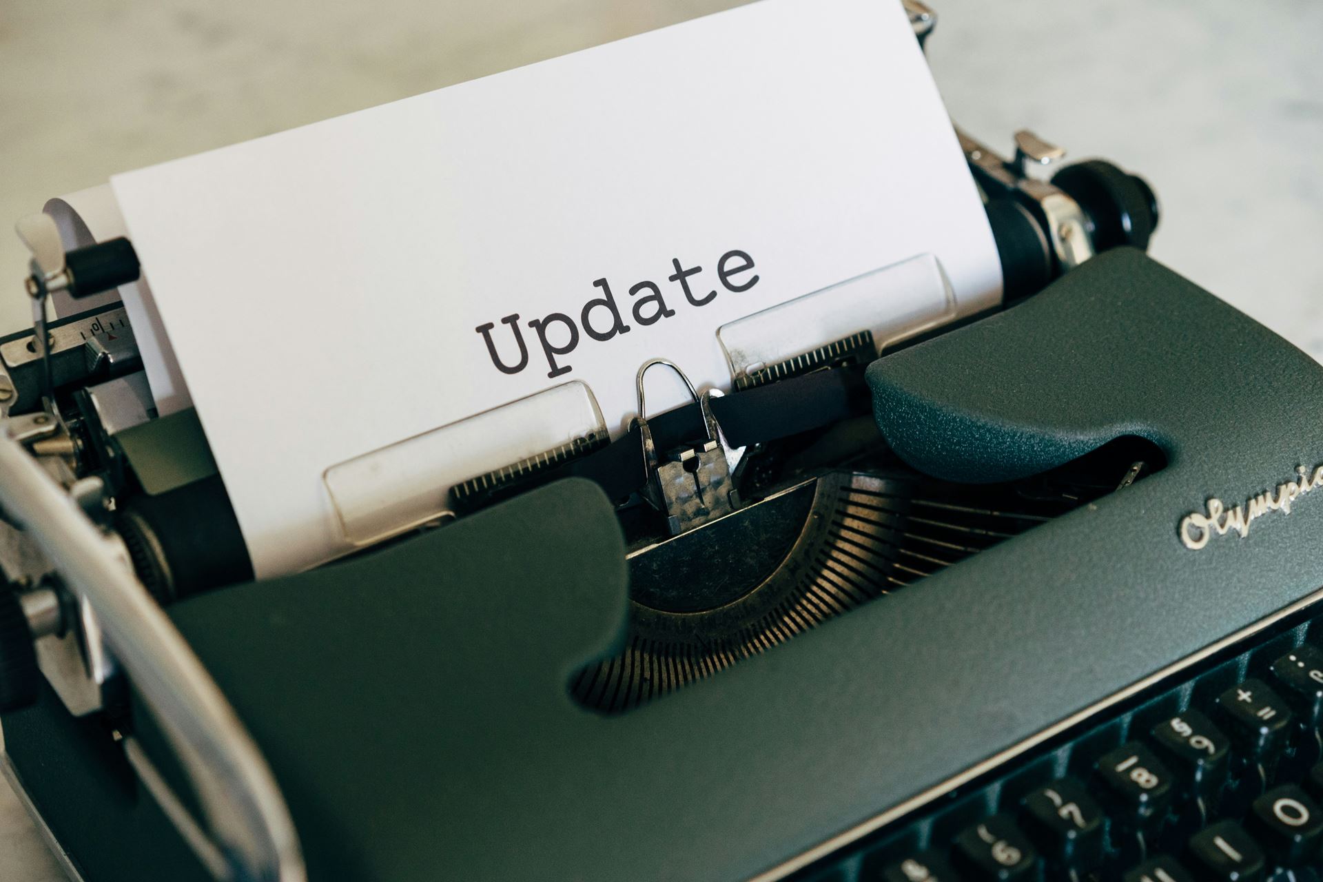 Typewriter with the word update printed on paper